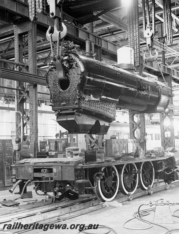 P20933
G class 233, boiler being lowered onto wheel assembly, overhead cranes, Fitting Shop, Block 3, Midland Workshops, front and side view from floor level

