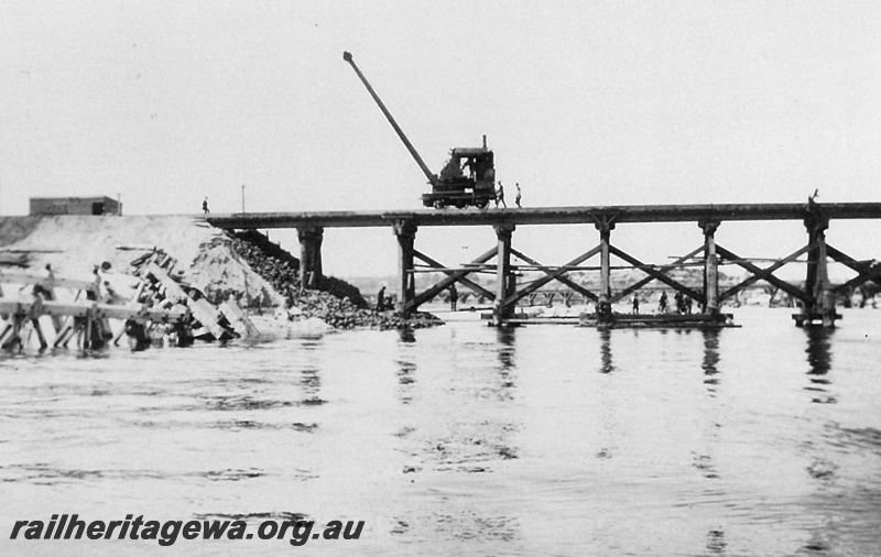 P20944
Reconstruction of Fremantle Railway Bridge after collapse in 1926 3 of 3, mobile crane, workers, Fremantle, ER line, side view of bridge framework from the Swan River
