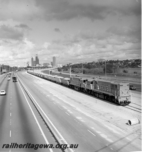 P20947
DB class 1584, another DB class diesel loco, double heading ballast train, Mitchell freeway, near Lake Monger, Joondalup line, side and front view, from elevated position
