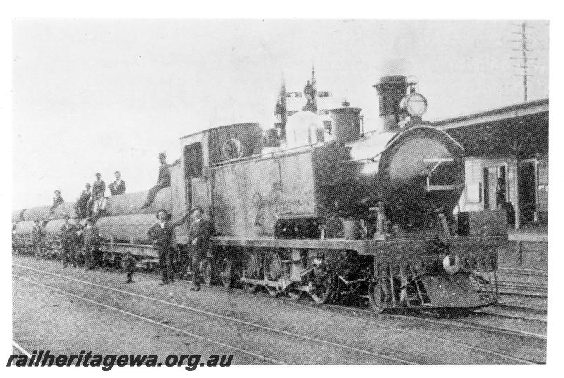 P21080
K Class 112 (later renumbered 191) on goods train loaded with first batch of locally made pipes for Goldfields Water Supply System, onlookers, Midland, ER line, side and front view
