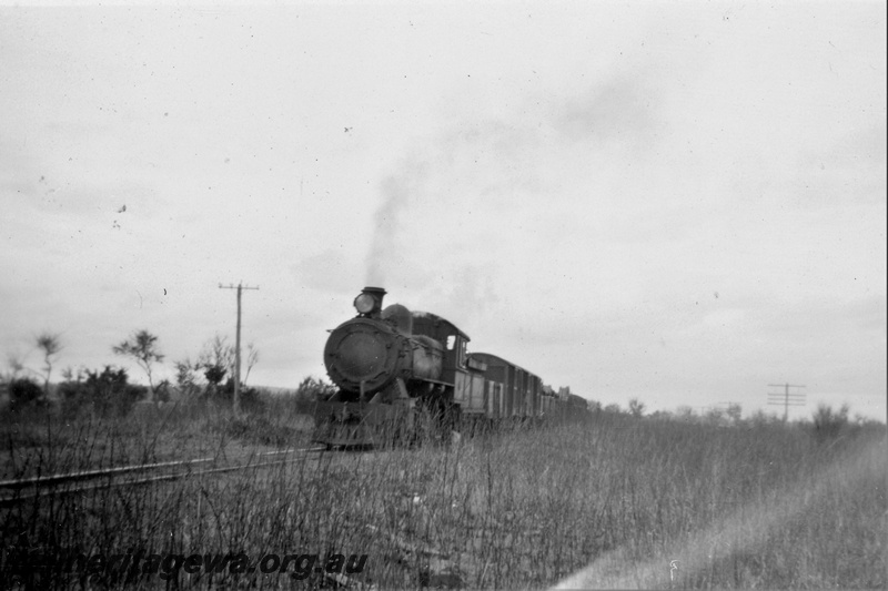 P21400
F  class steam loco  on goods train, unknown location, front and side view
