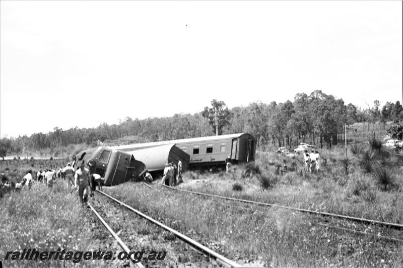 P21595
Derailment, X class 1005 on its side,  bogie van VA class 10220, AZ class 440 passenger carriage across tracks, near Parkerville, ER line,  onlookers, trackside view
