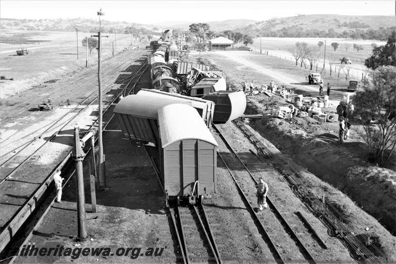 P21602
Scene of collision between goods trains, vans and wagons derailed, onlookers, water column, points, sidings, bracket signals, Spencers Brook, view from elevated position, ER line.
