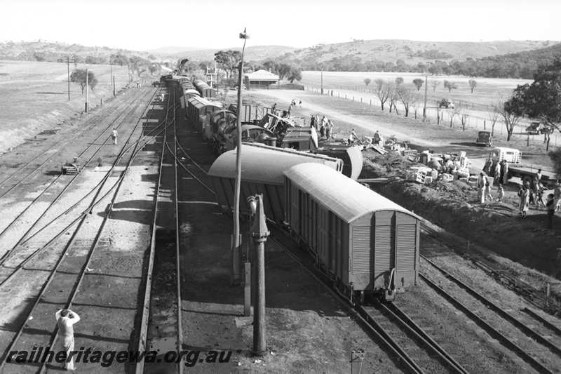 P21603
Scene of collision between goods trains, vans and wagons derailed, onlookers, flat top motor lorry, water column, points, sidings, bracket signals, Spencers Brook, ER line, view from elevated position
