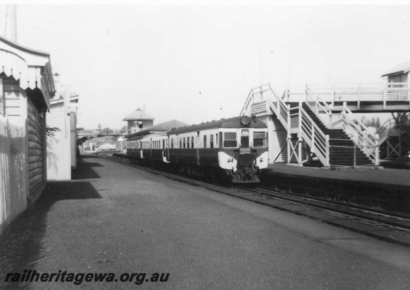 P21624
DMU 3 car set, platforms, station buildings, signal box, pedestrian footbridge, steps, Claremont, ER line, side and end view from platform 
