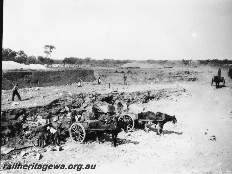 P22420
Preparing a railway water supply dam 2 of 3, horses, wagons, workers, roadway, view from elevated position
