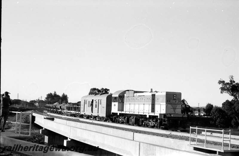 P22652
J class 101 hauling ballast train of WSH ballast wagons on construction of Midland to Forrestfield railway crossing Woodbridge triangle. ER line.

