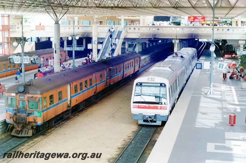 P22898
ADG Class 602, with another ADG, on a Midland to Fremantle service, EMU on Armadale service, awaiting departure, platforms 2, 6 & 7, overhead footbridge, escalators, roof, Perth City station, ER line, front and side views from elevated position
