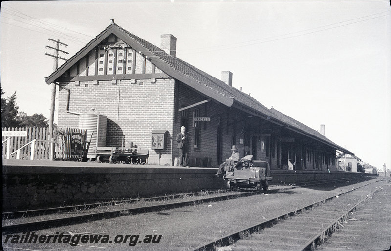 P22933
Station buildings, platform, luggage trolley on platform, passenger on platform, rail trolley on track with man aboard, tracks, Mt Barker, GSR line, trackside view
