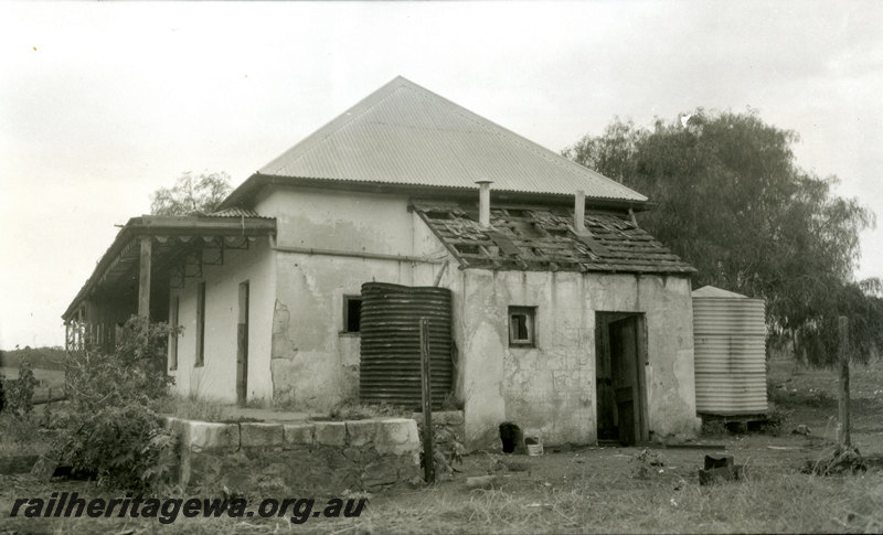 P22941
First railway station at Northampton GA line 1 of 4, station building in derelict condition, two water tanks, ground level view
