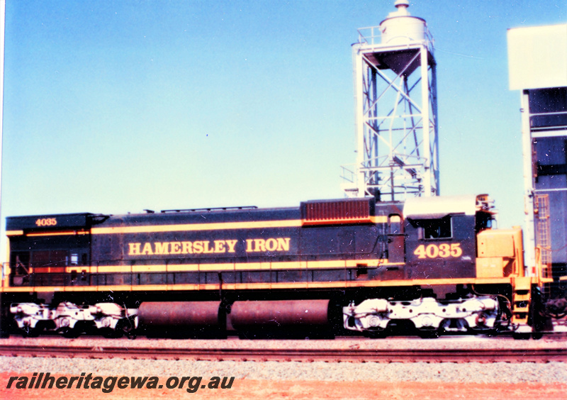 P23110
Hamersley Iron Alco M636 class 4035 in the green and yellow livery with silver bogies at Seven Mile, Dampier, side view
