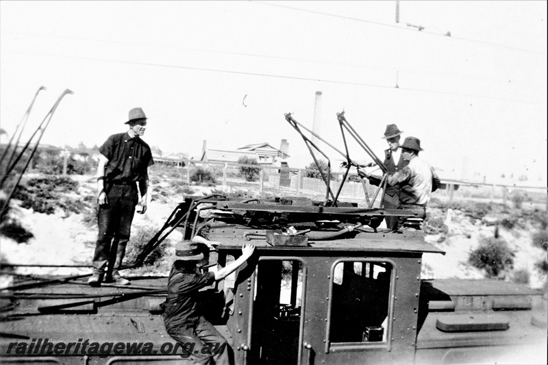 P23147
 State Electricity Commission electric locomotive 1, 3 of 6, 4 men on roof inspecting pantograph, view of roof, c1930s
