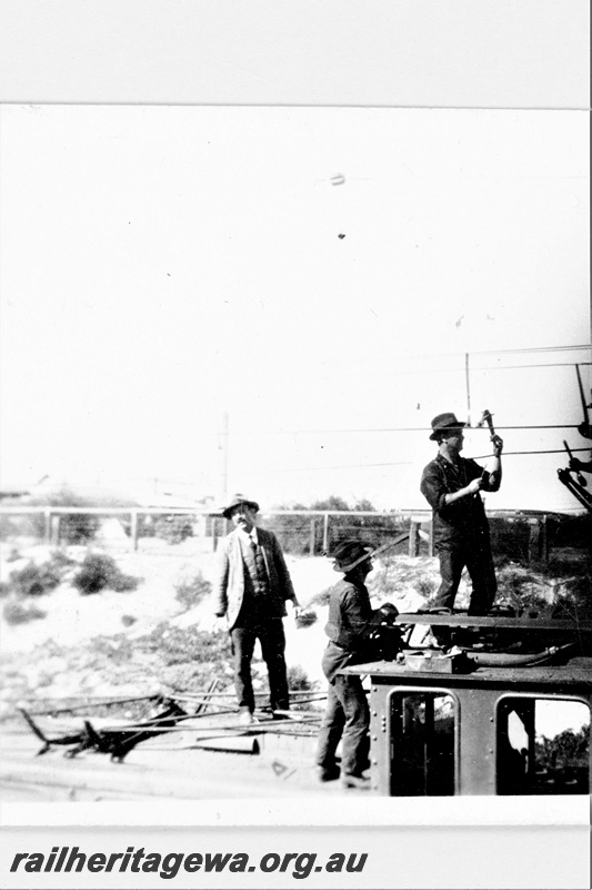 P23149
 State Electricity Commission electric locomotive 1, 5 of 6,3 men on top of loco, close up view, c1930s
