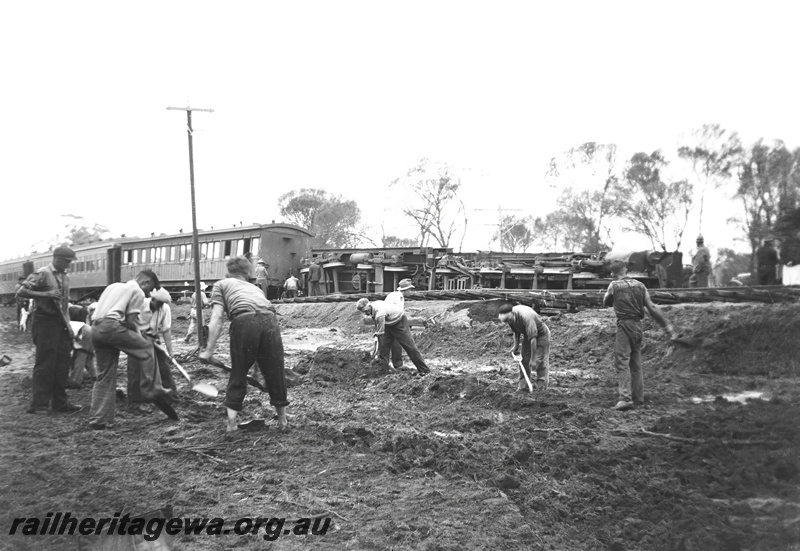 P23289
P class 444 on No. 8 Albany express derailed and laying on its side between Highbury and Narrogin,on the 23rd of January, 1939, GSR line, passenger carriages, workers clearing the site, view across the track,. See also P20120
