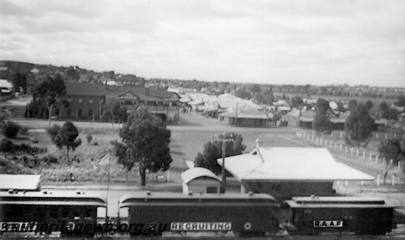 P23517
AG class 41, AG class 44 and Z class 74 with a clerestory roof on the RAAF Recruiting Train,  Corrigin, elevated view taken from the water tower showing the buildings on the station platform including the top half of the Traffic Office, overall side on view, NWM line
