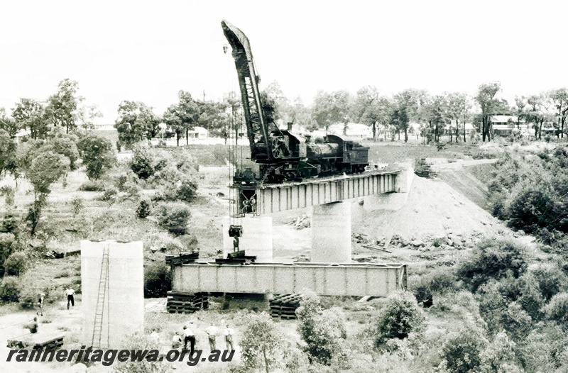 P23606
Construction of concrete and steel bridge over Collie River, crane, steam loco, workers, BN line, elevated distant view of site 

