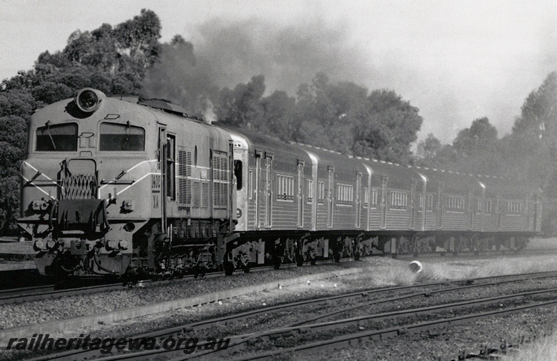 P23607
XA class 1402 on a train of Queensland carriages, siding,  front and side view from trackside
