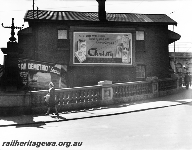 P23621
Signal box C, with advertising, pedestrian, Beaufort Street, Perth station, ER line, view of the rear of the building from the street
