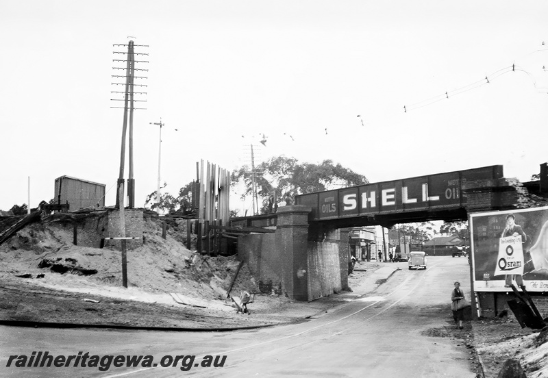 P23623
Widening of Mt Lawley subway, advertising on bridge, hoarding, Mt Lawley, ER line, view under Shell bridge taken from road level

