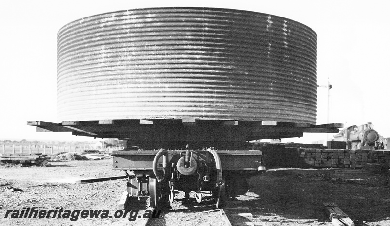 P23630
Water tank being transported on flat wagon, E class steam loco, signal, Karalee, EGR line, end view from track level
