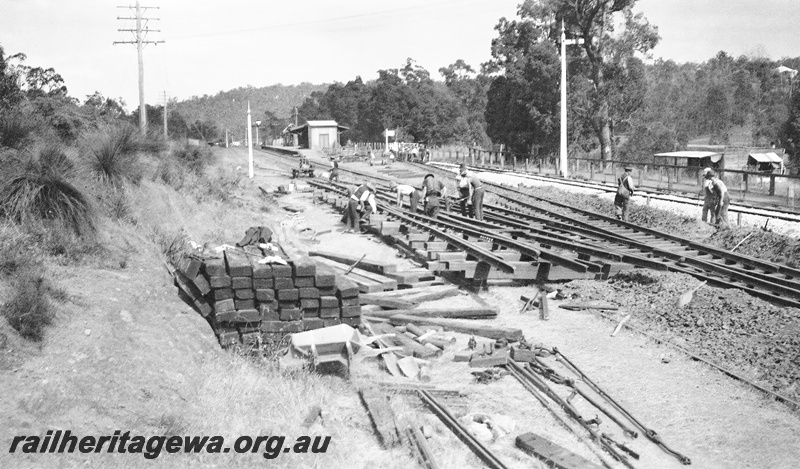 P23631
Construction of double crossover trackwork, signals, workers, trackside buildings, Parkerville, ER line, view from elevated position  

