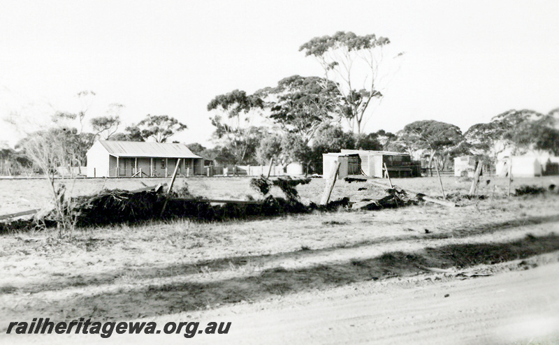 P23641
Washaways, station building, sheds, water was 2 feet above last shed, Nyabing, KP line, ground level view
