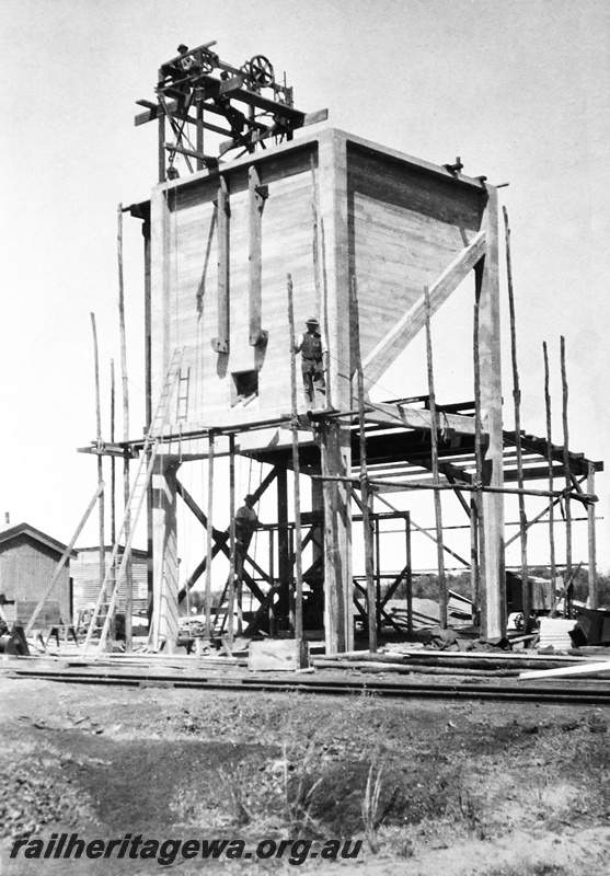 P23663
Coal stage under construction, 3of 4, workers, other trackside sheds, Caron, EM line, view of structure from across tracks
