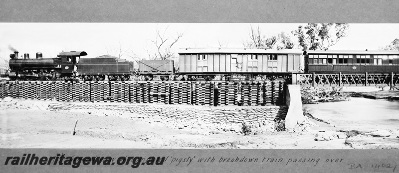 P23676
MRWA locomotive C class 14 on breakdown train including KB class workman's van,  GR class water tanker, and J/JA class carriage, on pigsty adjacent to cast iron truss bridge over the Irwin River, MR line, side view
