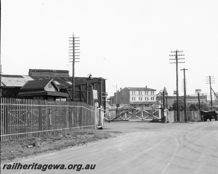P23772
Level crossing with crossing gates, picket fence, Moore street, Perth, view along the road
