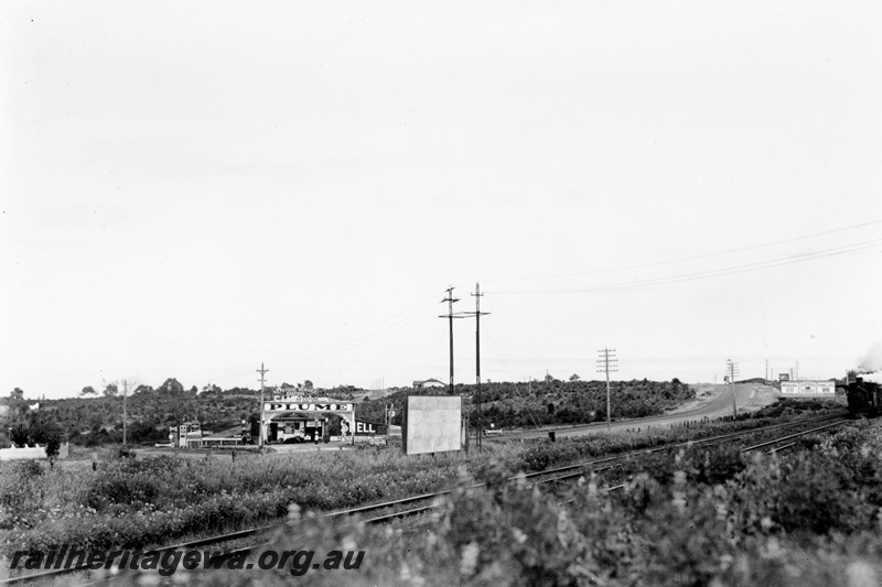 P23779
Track with trackside advertising signs, train on the RHS, 