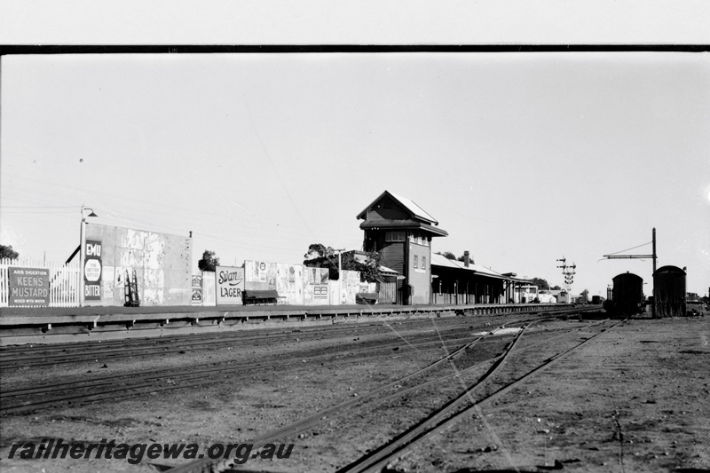 P23790
Elevated signal box, station buildings, bracket signal, loading gauge, advertising hoardings, Southern Cross, EGR line, overall view of the yard looking west
