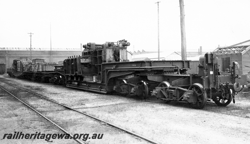 P23818
QX class 2300 trolley wagon , laden with Baldwin Ormes CM50 forging press, workshop buildings, tracks, Midland, ER line, side and end view. See P23818
