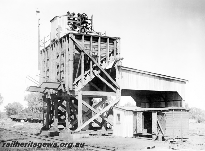 P23845
Mechanical coaling plant, trackside building, van, wagons, track level view
