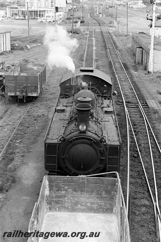 P23882
DD class 592, top of loco, GER class wagon with ridge pole, internal view, level crossing, signals, wagon, trackside buildings, Bunbury, SWR line, front view from elevated position

