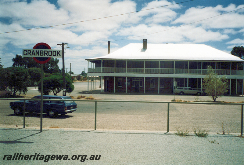 P23934
Station nameboard, Tambellup, GSR line, hotel in the background
