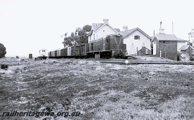 P23965
RA class on goods train, station building, wagons, Walkaway, MR line, side and front view from ground level
