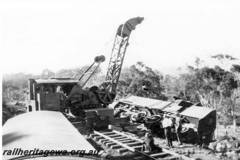 P23986
Derailment of No 42 Mixed at Cape Horn M line on 19271025, 1 of 2, DS class 387 off tracks, on side, mobile crane, workers, trackside view. See also P01669, P01800, P018801, P07273-278, P 21988, P23987  
