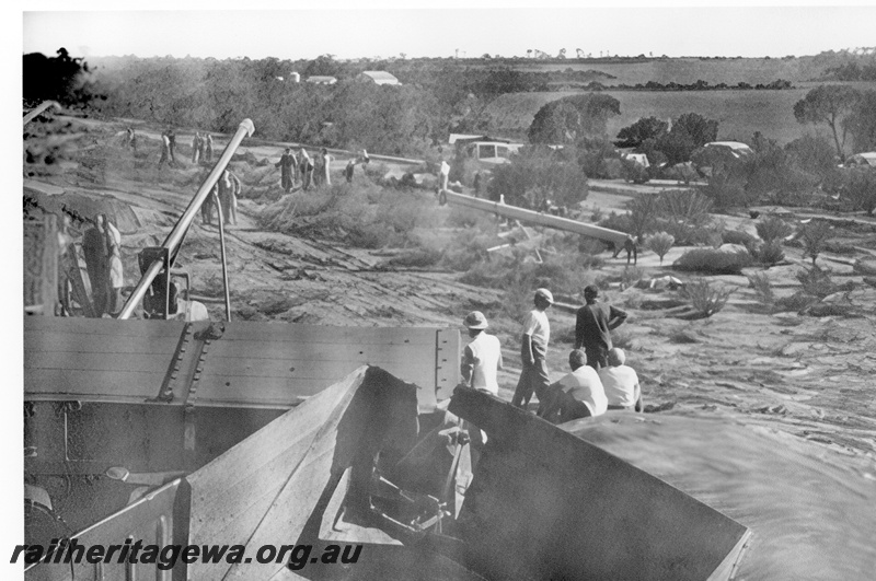 P23992
Derailment of No 60 Fast Goods near Nalkain WLB line, 5 of 7, damaged wagons, workers, onlookers, truck, elevated view
