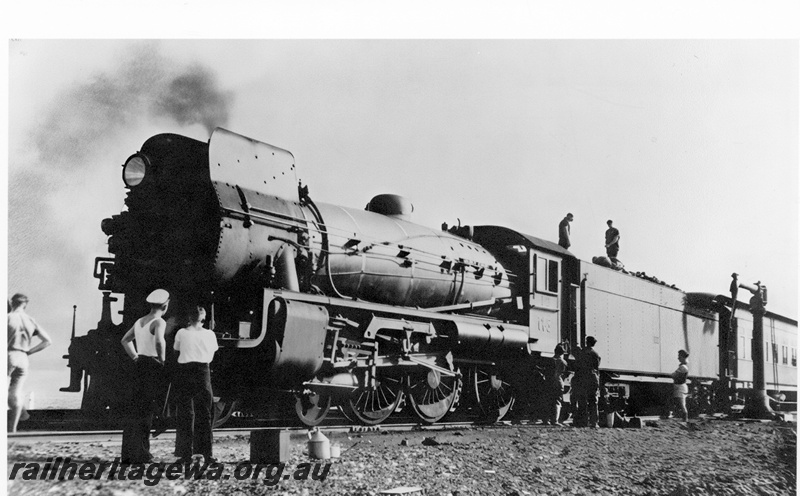 P23996
Commonwealth Railways C class 65, with smoke deflectors on each side of the chimney, water crane, workers, onlookers, TAR line, front and side view
