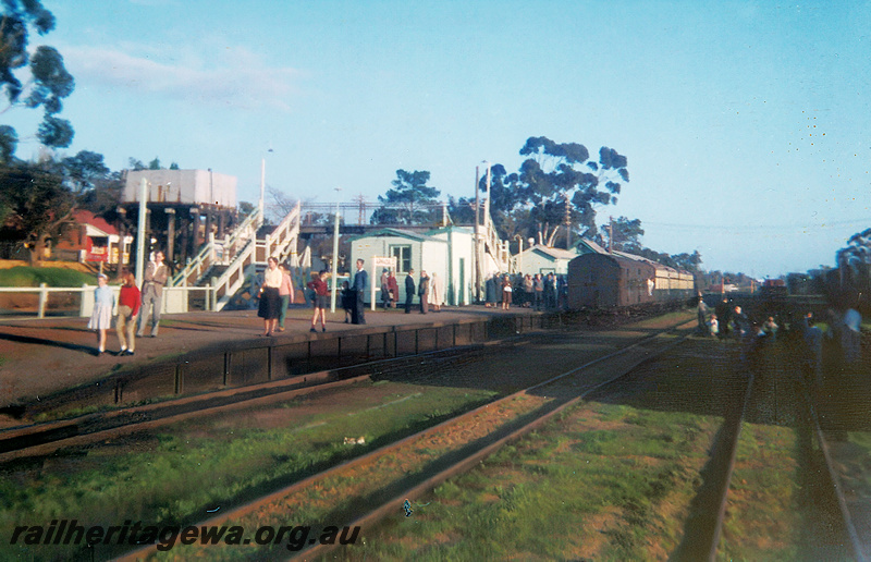 P24000
Footbridge, water tower with a 25,000 gallon cast iron tank painted white, station buildings, rake of carriages at the platform,  Armadale, SWR line, on ARHS tour train Perth to Perth via Fremantle, Jandakot and Armadale, overall view of the station precinct
