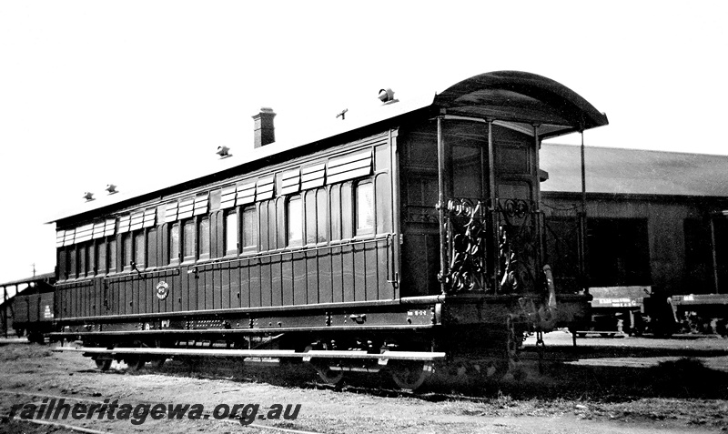 P24033
MRWA KA class 17, passenger carriage with end platform with wrought ornate iron guard rail, shed in background, side and end view from trackside
