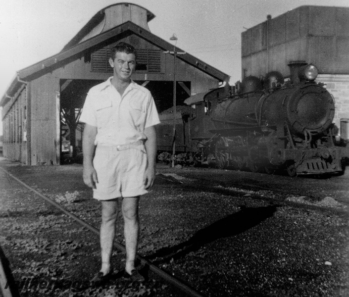 P24040
P class steam loco, man standing on track in front of loco shed, Cue, NR line, side and front view from track level
