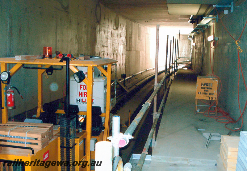 P24048
Track laid on concrete plinths, machinery, east side of new  Esplanade station, Mandurah line, view inside tunnel

