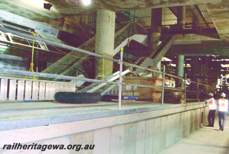 P24052
Platform, pillars, escalator frame, workers, William Street station, Perth Underground, view looking south from track level
