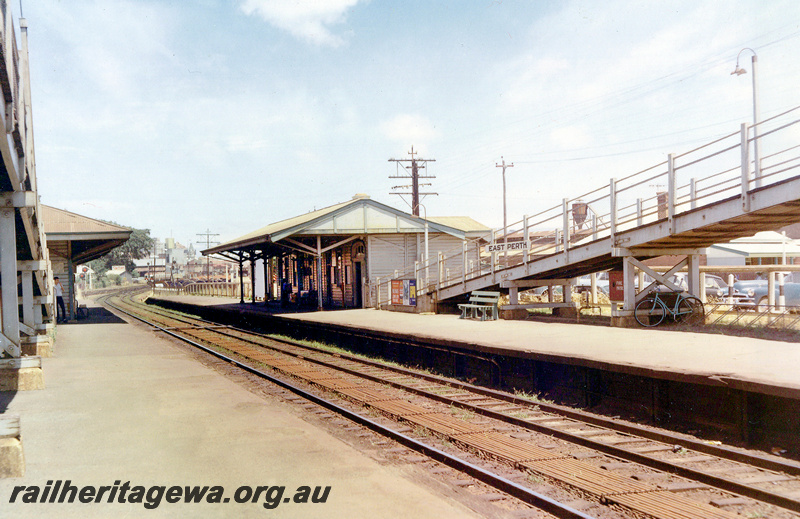 P24065
Station buildings, footbridge, nameboard, point rodding, platforms, East Perth, ER line, view along the tracks
