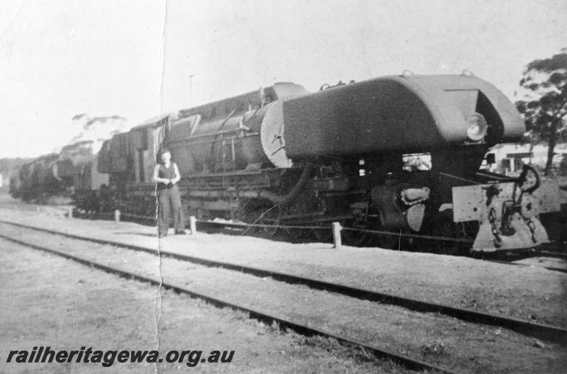 P24086
ASG class loco, man standing beside it, with full length cowling, side and front view

