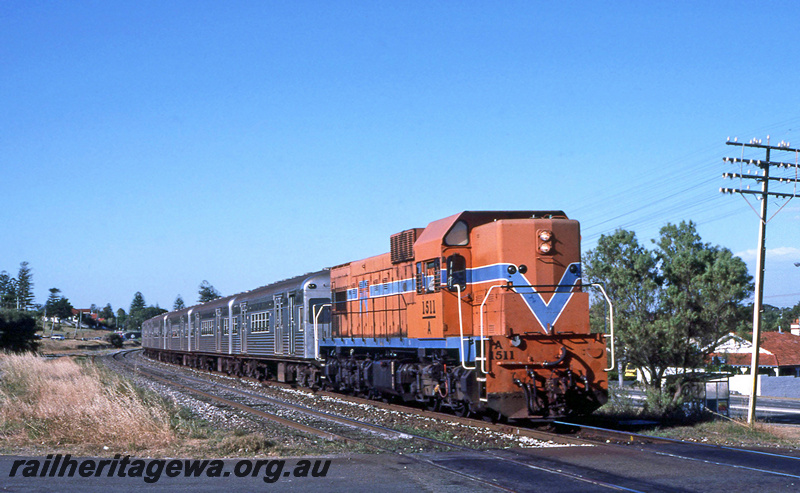 P24093
A class 1511, on suburban passenger train with Queensland Rail leased carriages, level crossing Victoria Street, ER line, side and front view
