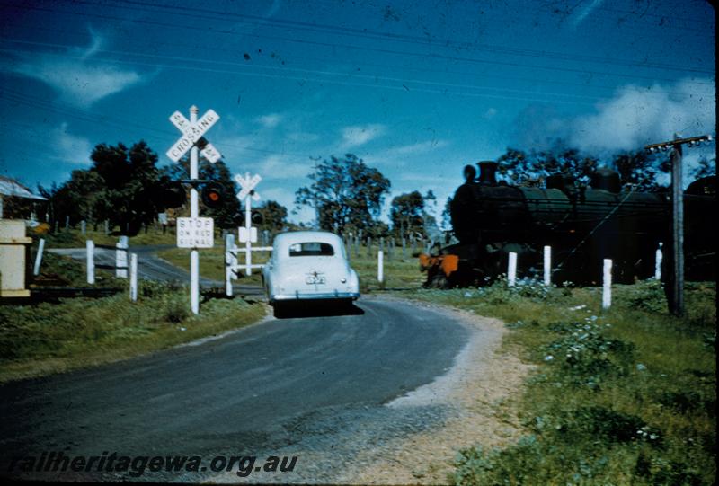T00255
PM class, level crossing with flashing lights, Holden car.
