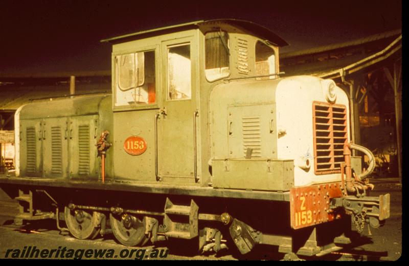 T00723
Z class 1153, green with white front and red grill livery, hand operated fuel pump visible on the side of the long hood, side and front night time view, Bunbury, SWR line, same as T00642
