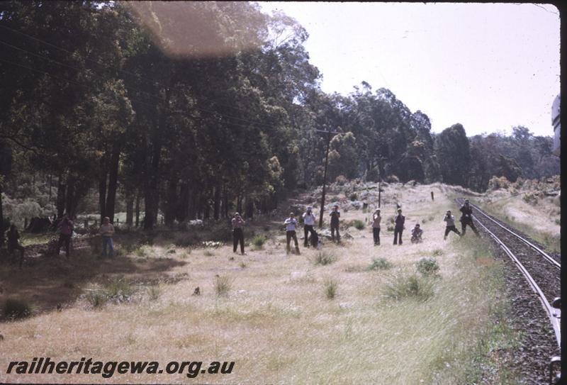 T01803
Railway enthusiasts in photo line along side track
